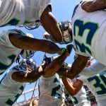 Seattle Seahawks players lock arms in a group before warming up before a game against the Denver Broncos at Broncos Stadium at Mile High on September 9, 2018 in Denver, Colorado. (Photo by Dustin Bradford/Getty Images)