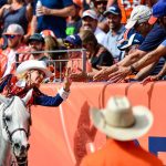 Ann Judge, riding Denver Broncos mascot Thunder, celebrates with fans after a Denver Broncos score against the Seattle Seahawks at Broncos Stadium at Mile High on September 9, 2018 in Denver, Colorado. (Photo by Dustin Bradford/Getty Images)