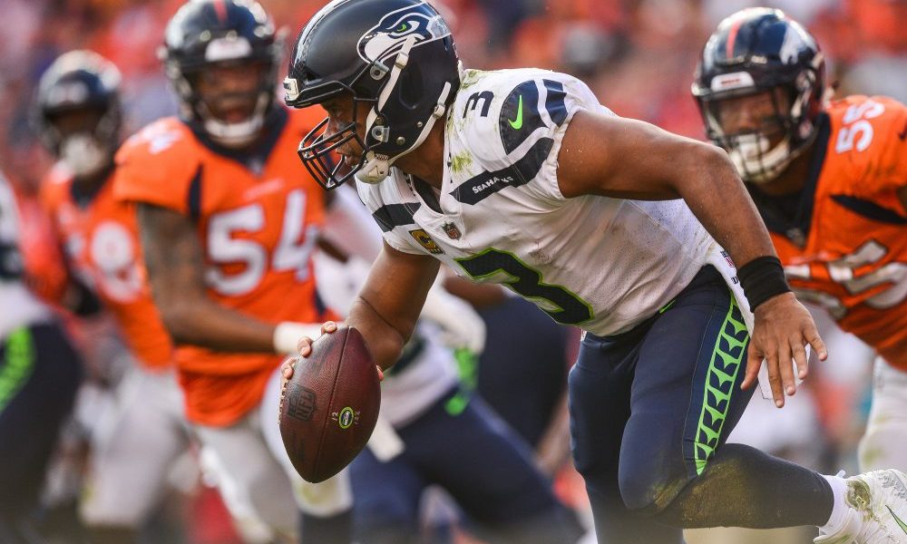 Quarterback Russell Wilson #3 of the Seattle Seahawks scrambles under pressure in the fourth quarte...