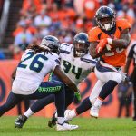 Running back Royce Freeman #28 of the Denver Broncos carries the ball and tries to avoid a tackle attempt by cornerback Shaquill Griffin #26 and defensive end Rasheem Green #94 of the Seattle Seahawks at Broncos Stadium at Mile High on September 9, 2018 in Denver, Colorado. (Photo by Dustin Bradford/Getty Images)