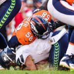 Quarterback Russell Wilson #3 of the Seattle Seahawks is hit by linebacker Von Miller #58 of the Denver Broncos after recovering a fumble off of a bad snap in the fourth quarter of  at Broncos Stadium at Mile High on September 9, 2018 in Denver, Colorado. (Photo by Dustin Bradford/Getty Images)