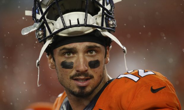 Quarterback Paxton Lynch #12 of the Denver Broncos walks off the field in the rain following his 27...