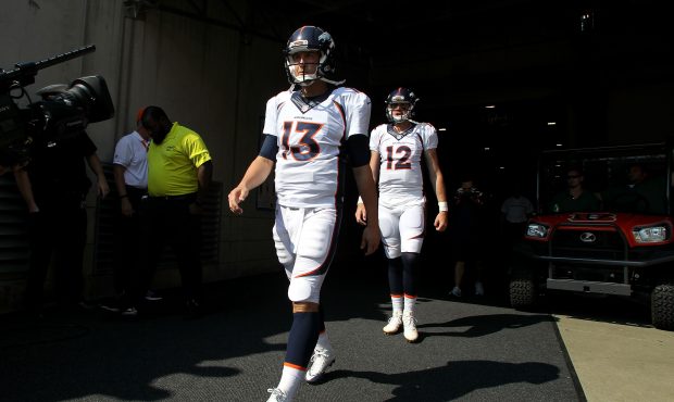 Trevor Siemian #13 of the Denver Broncos and Paxton Lynch #12 of the Denver Broncos walk out to the...