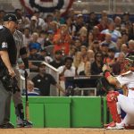 MIAMI, FL - JULY 11:  Yadier Molina #4 of the St. Louis Cardinals and the National League takes a photograph of Nelson Cruz #23 of the Seattle Mariners and the American League and umpire Joe West in the sixth inning during the 88th MLB All-Star Game at Marlins Park on July 11, 2017 in Miami, Florida.  (Photo by Mike Ehrmann/Getty Images)