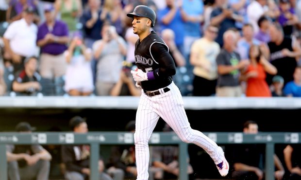 DENVER, CO - JUNE 20:  Carlos Gonzalez #5 of the Colorado Rockies circles the bases after hitting a...