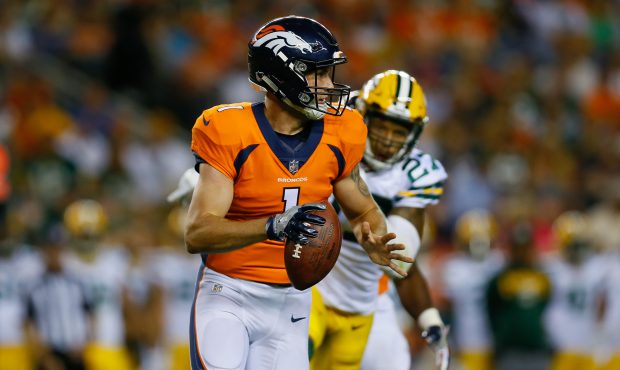DENVER, CO - AUGUST 26: Quarterback Kyle Sloter #1 of the Denver Broncos runs from safety Josh Jone...