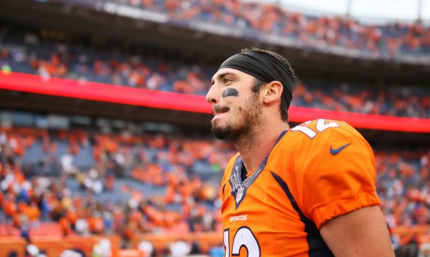Quarterback Paxton Lynch #12 of the Denver Broncos walks off the field after losing 23-16 to the At...