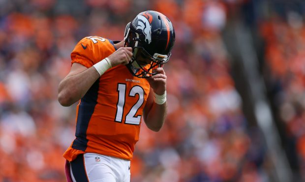 DENVER, CO - OCTOBER 9: Quarterback Paxton Lynch #12 of the Denver Broncos walks off the field in t...