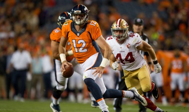 DENVER, CO - AUGUST 20:  Quarterback Paxton Lynch of the Denver Broncos rushes under pressure by li...