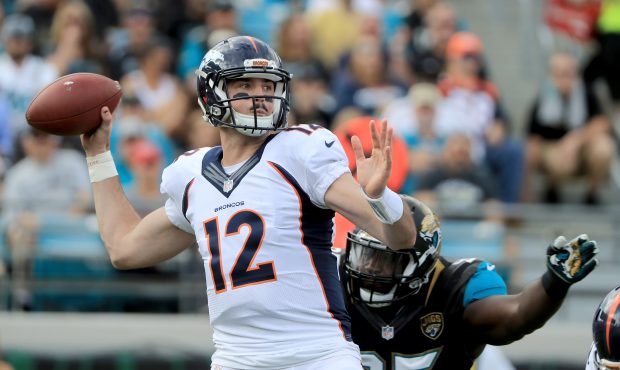 JACKSONVILLE, FL - DECEMBER 04:   Paxton Lynch #12 of the Denver Broncos attempts a pass as Abry Jo...