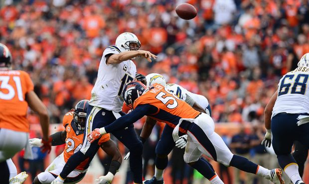 DENVER, CO - OCTOBER 30:  Quarterback Philip Rivers #17 of the San Diego Chargers passes while bein...