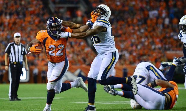 Denver Broncos running back Mike Anderson (L) is tackled by