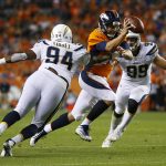 DENVER, CO - SEPTEMBER 11:  Quarterback Trevor Siemian #13 of the Denver Broncos is tackled by Corey Liuget #94 and defensive end Joey Bosa #99 of the Los Angeles Chargers in the third quarter at Sports Authority Field at Mile High on September 11, 2017 in Denver, Colorado. (Photo by Justin Edmonds/Getty Images)