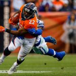 DENVER, CO - SEPTEMBER 17:  Running back C.J. Anderson #22 of the Denver Broncos avoids a tackle attempt by outside linebacker Jaylon Smith #54 of the Dallas Cowboys in the first half of a game at Sports Authority Field at Mile High on September 17, 2017 in Denver, Colorado. (Photo by Justin Edmonds/Getty Images)