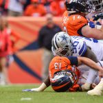 DENVER, CO - SEPTEMBER 17:  Quarterback Trevor Siemian #13 of the Denver Broncos is sacked by defensive end Demarcus Lawrence #90 of the Dallas Cowboys forcing a fumble and turnover in the second quarter of a game at Sports Authority Field at Mile High on September 17, 2017 in Denver, Colorado. (Photo by Dustin Bradford/Getty Images)