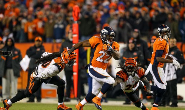 DENVER, CO - DECEMBER 28:  Running back C.J. Anderson #22 of the Denver Broncos breaks away from ta...