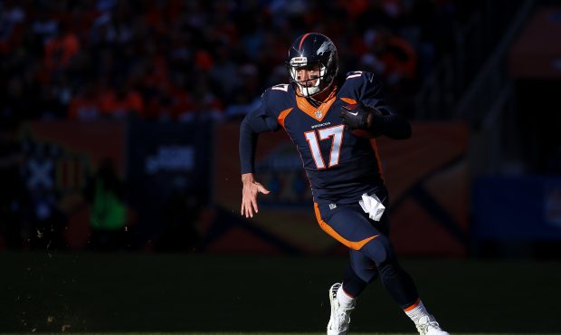 DENVER, CO - DECEMBER 13:  Quarterback Brock Osweiler #17 of the Denver Broncos rushes against the ...
