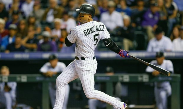 DENVER, CO - SEPTEMBER 6:  Carlos Gonzalez #5 of the Colorado Rockies watches his RBI single during...