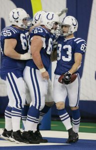 INDIANAPOLIS - DECEMBER 26: Brandon Stokley #83 of the Indianapolis Colts celebrates with teammates Jeff Saturday #63 and Dallas Clark #44 of the Indianapolis Colts after catching touchdown pass number 49 for the season from teammate/quarterback Peyton Manning #18 on December 26, 2004 at the RCA Dome in Indianapolis, Indiana. Peyton Manning surpassed quarterback Dan Marino's NFL regular season record of 48 as Manning threw for his 49th record-breaking touchdown en route to leading the Colts over the Chargers 34-31 in overtime. (Photo by Robert Laberge/Getty Images)