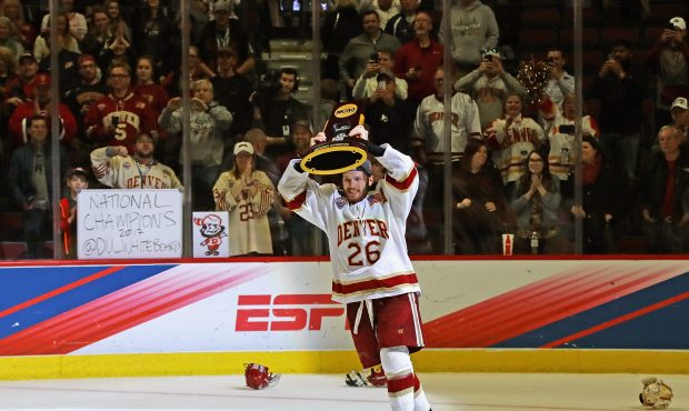 CHICAGO, IL - APRIL 08: Evan Janssen #26 of the Denver Pioneers holds the trophy after a win over t...