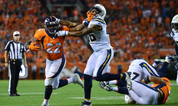DENVER, CO - SEPTEMBER 11:  Running back C.J. Anderson #22 of the Denver Broncos stiff arms inside ...