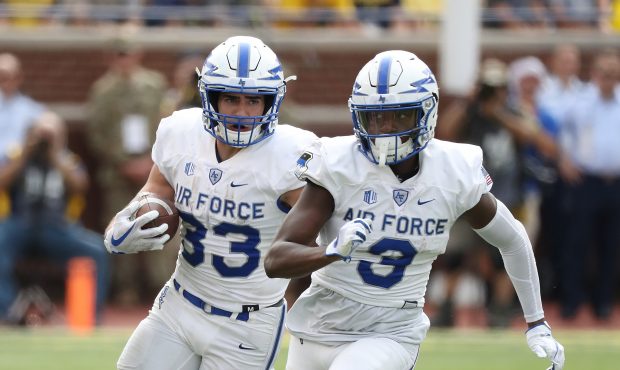 ANN ARBOR, MI - SEPTEMBER 16: Timothy McVey #33 of the Air Force Falcons runs for a first down as t...