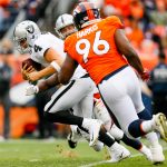 DENVER, CO - OCTOBER 1:  Quarterback Derek Carr #4 of the Oakland Raiders looks to avoid a hit by defensive end Shelby Harris #96 of the Denver Broncos in the third quarter of a game at Sports Authority Field at Mile High on October 1, 2017 in Denver, Colorado. (Photo by Justin Edmonds/Getty Images)