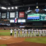 PHOENIX, AZ - OCTOBER 04: Members of the Colorado Rockies and Arizona Diamondbacks stand for the National Anthem before the start of the National League Wild Card game at Chase Field on October 4, 2017 in Phoenix, Arizona.  (Photo by Norm Hall/Getty Images)