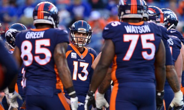 Quarterback Trevor Siemian #13 of the Denver Broncos talks with other players as players warm up be...