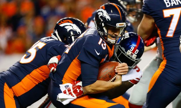 DENVER, CO - OCTOBER 15:  Quarterback Trevor Siemian #13 of the Denver Broncos is tackled by defens...