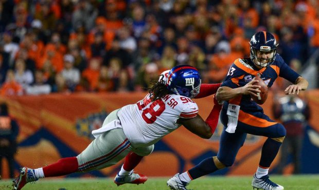 DENVER, CO - OCTOBER 15: Quarterback Trevor Siemian #13 of the Denver Broncos is sacked by defensiv...