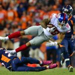 DENVER, CO - OCTOBER 15: Tight end Evan Engram #88 of the New York Giants flies through the air after being tackled by free safety Darian Stewart #26 of the Denver Broncos at Sports Authority Field at Mile High on October 15, 2017 in Denver, Colorado. (Photo by Dustin Bradford/Getty Images)