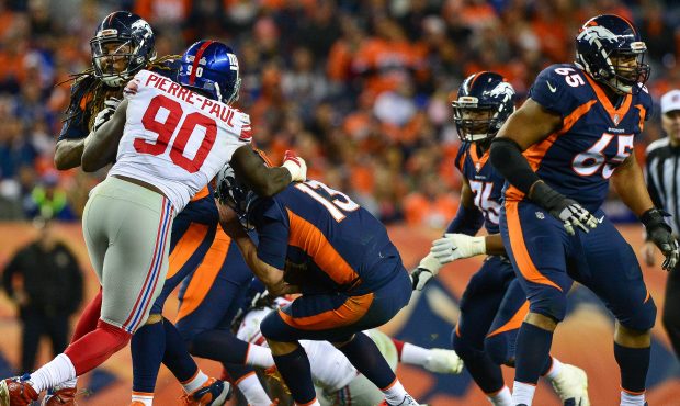 DENVER, CO - OCTOBER 15: Quarterback Trevor Siemian #13 of the Denver Broncos is sacked by defensiv...