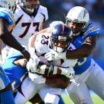 CARSON, CA - OCTOBER 22:  Darius Philon #93 of the Los Angeles Chargers tackles Devontae Booker #23 of the Denver Broncos during the second quarter of the game at the StubHub Center on October 22, 2017 in Carson, California.  (Photo by Harry How/Getty Images)