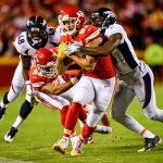 KANSAS CITY, MO - OCTOBER 30: Tight end Travis Kelce #87 of the Kansas City Chiefs fights through the tackle attempt of cornerback Aqib Talib #21 of the Denver Broncos during the first half of the game at Arrowhead Stadium on October 30, 2017 in Kansas City, Missouri. ( Photo by Peter Aiken/Getty Images )