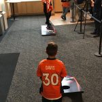 Denver Broncos cornerback Chris Harris Jr. and a young fan play bean-bag toss during Drive for Life 20.