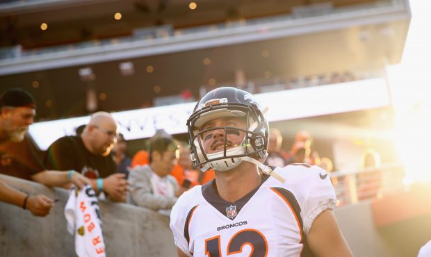 Paxton Lynch #12 of the Denver Broncos runs on to the field to warm up for their game against the S...