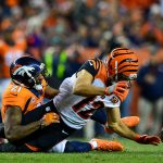 DENVER, CO - NOVEMBER 19:  Wide receiver Alex Erickson #12 of the Cincinnati Bengals Fumbles the ball after being tackled by cornerback Aqib Talib #21 of the Denver Broncos at Sports Authority Field at Mile High on November 19, 2017 in Denver, Colorado. Ericsson recovered the ball. (Photo by Dustin Bradford/Getty Images)