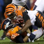 DENVER, CO - NOVEMBER 19:  Quarterback Brock Osweiler #17 of the Denver Broncos is sacked by Carlos Dunlap #96 of the Cincinnati Bengals at Sports Authority Field at Mile High on November 19, 2017 in Denver, Colorado.  (Photo by Matthew Stockman/Getty Images)