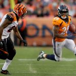 DENVER, CO - NOVEMBER 19:  Jamaal Charles #28 of the Denver Broncos attepmts to elude Darqueze Dennard #21 of the Cincinnati Bengals at Sports Authority Field at Mile High on November 19, 2017 in Denver, Colorado.  (Photo by Matthew Stockman/Getty Images)