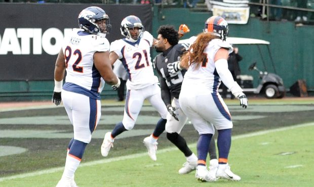 Michael Crabtree #15 of the Oakland Raiders fights with Aqib Talib #21 of the Denver Broncos in the...
