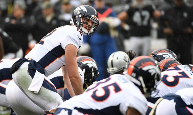 Paxton Lynch #12 of the Denver Broncos goes under center against the Oakland Raiders during their N...