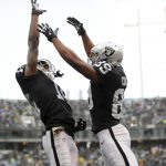 Amari Cooper #89 of the Oakland Raiders celebrates with Johnny Holton #16 after a nine-yard touchdown catch against the Denver Broncos during their NFL game at Oakland-Alameda County Coliseum on November 26, 2017 in Oakland, California.  (Photo by Robert Reiners/Getty Images)