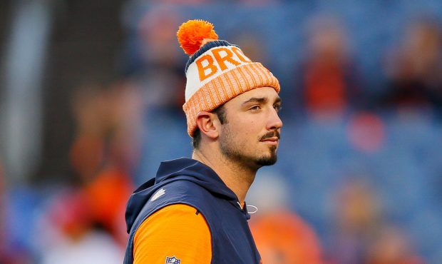 Quarterback Paxton Lynch #12 of the Denver Broncos looks on from the field during warm up before a ...