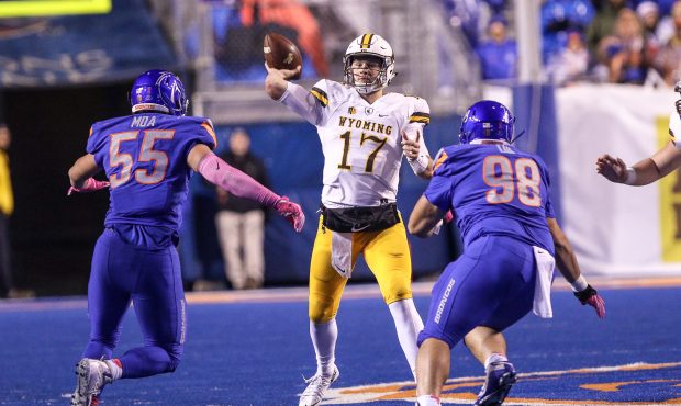 Quarterback Josh Allen #17 of the Wyoming Cowboys gets a pass off during first half action against ...