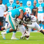 Kenyan Drake #32 of the Miami Dolphins rushes during the second quarter against Will Parks #34 of the Denver Broncos at the Hard Rock Stadium on December 3, 2017 in Miami Gardens, Florida.  (Photo by Chris Trotman/Getty Images)