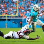 Kenyan Drake #32 of the Miami Dolphins rushes during the third quarter against Will Parks #34 of the Denver Broncos at the Hard Rock Stadium on December 3, 2017 in Miami Gardens, Florida.  (Photo by Chris Trotman/Getty Images)