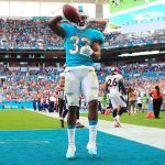 Kenyan Drake #32 of the Miami Dolphins celebrates after scoring a tocuhdown in the third quarter against the Denver Broncos at the Hard Rock Stadium on December 3, 2017 in Miami Gardens, Florida.  (Photo by Chris Trotman/Getty Images)