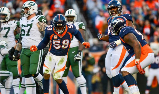 Outside linebacker Von Miller #58 of the Denver Broncos celebrates along with Shelby Harris #96 and...
