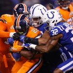 C.J. Anderson #22 of the Denver Broncos is tackled by T.J. Green #32 of the Indianapolis Colts during the first half at Lucas Oil Stadium on December 14, 2017 in Indianapolis, Indiana.  (Photo by Joe Robbins/Getty Images)